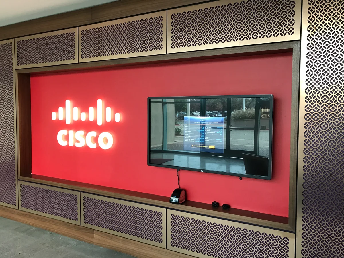 Illuminated white Cisco logo set into a red lobby display