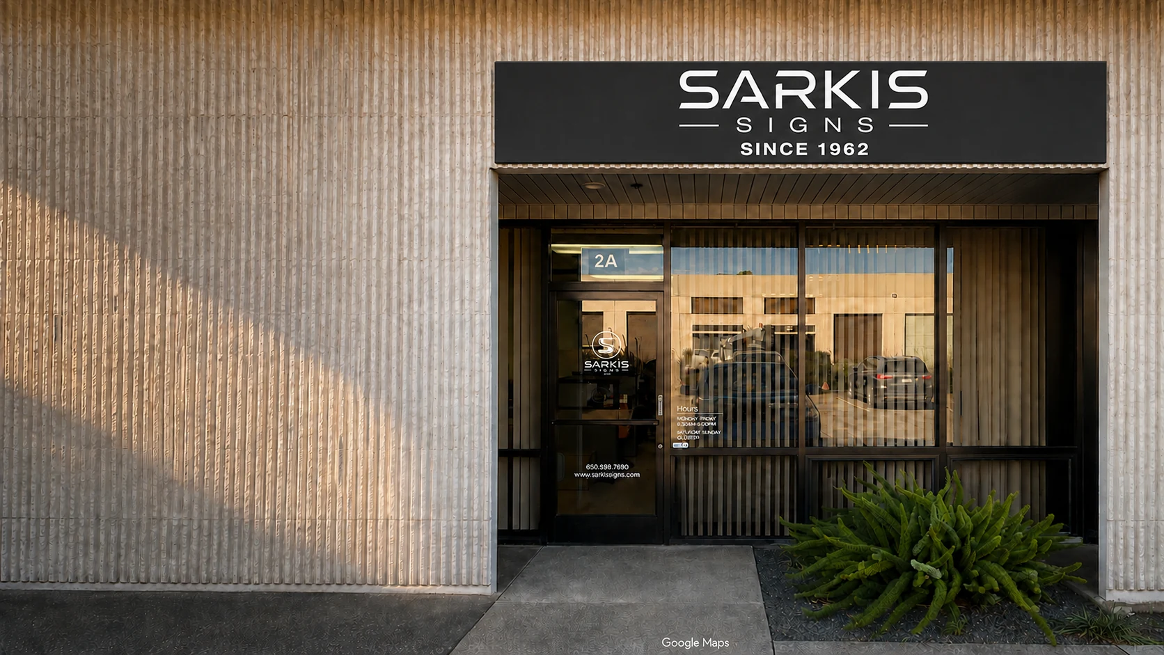 AI-assisted perspective study of the Sarkis Signs storefront, preserving its signage and entrance